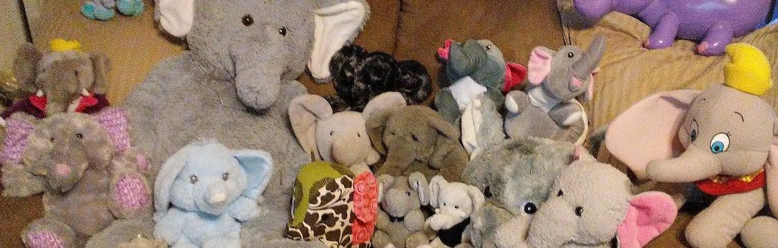 A collection of stuffed elephants of varying colors and sizes